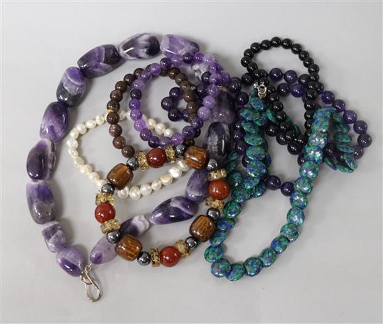 Three assorted necklace including amethyst and five assorted bracelets.